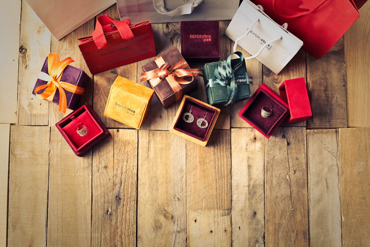 about-us Elegant jewelry gifts with shopping bags on wooden floor, perfect for holiday celebrations.