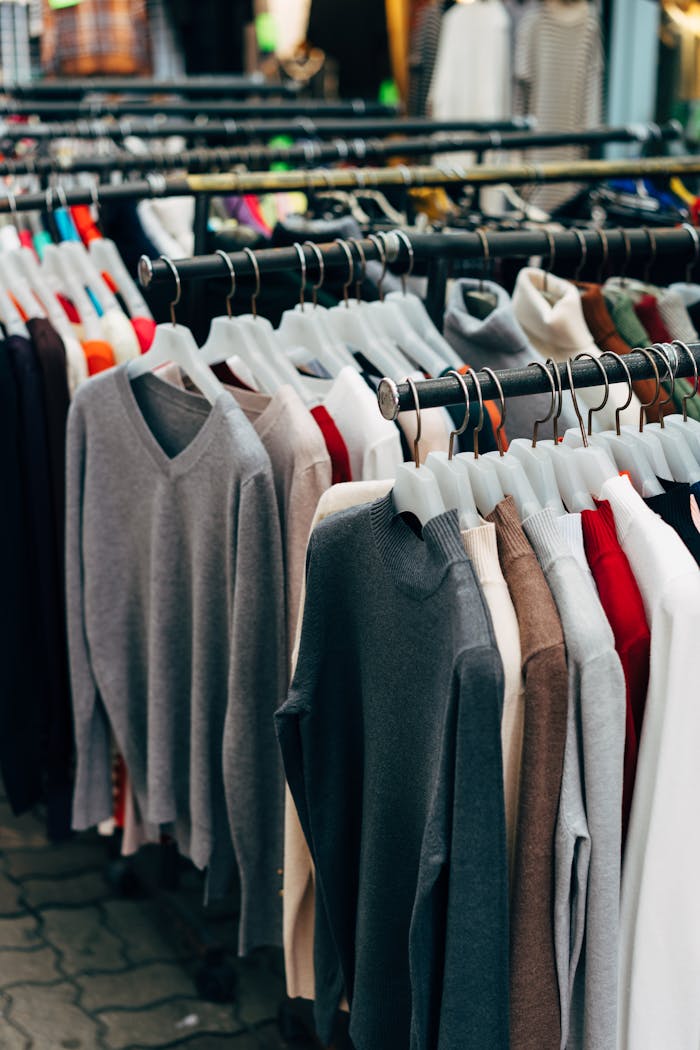 A collection of colorful clothing on racks in a retail store setting.