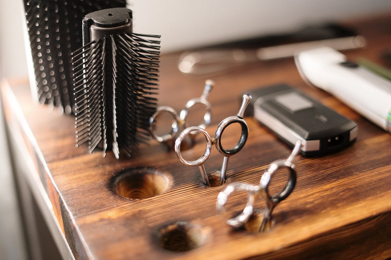about-bg Close-up of barber tools on a stylish wooden counter, perfect for a salon setting.