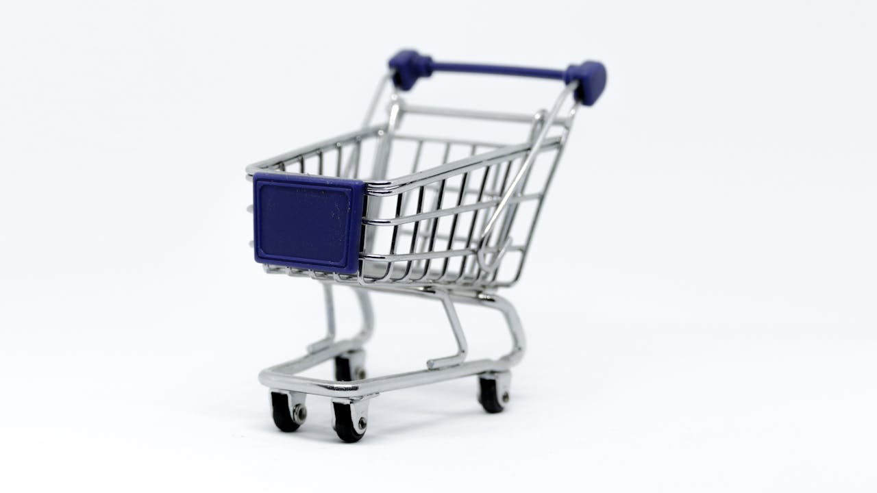 home-hero A modern miniature shopping cart on a clean white background, perfect for e-commerce concepts.